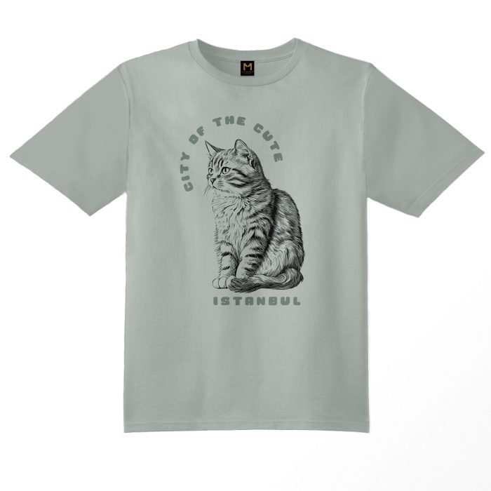 Sage green T-shirt featuring a graphic of a kitten cat sitting on its paws with the text 'Istanbul, City of the Cute available on cat museum Istanbul