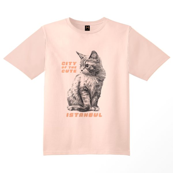 Pink T-shirt featuring a graphic of a kitten cat sitting on its paws with the text 'Istanbul, City of the Cute available on cat museum Istanbul